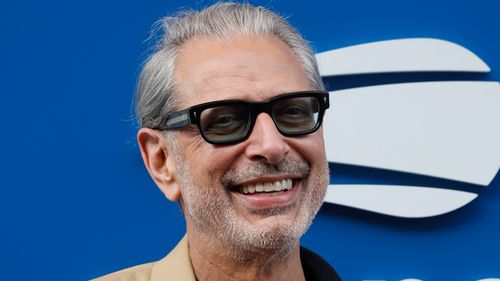 photo of jeff goldblum wearing dark glasses and beige jacket