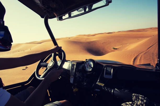 driving quad bike, buggy at dubai desert sand dunes - dune buggy man imagens e fotografias de stock