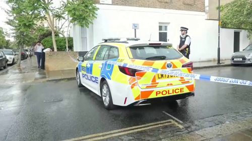 there is a police car parked in front of a building