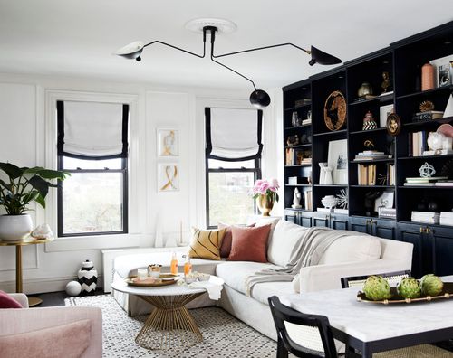 striking living room with black gallery wall and white couch