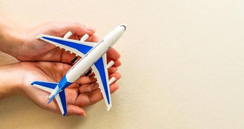 Hands holding airplane. Airline crisis, aviation tourism support solutions. Travel insurance due to coronavirus covid-19 pandemic. Airport reopening concept. photo