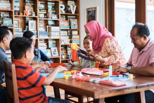 multi-generation family making wau bulan at home - making wau stock pictures, royalty-free photos & images