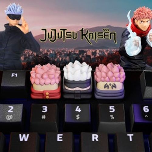 May include: Three keycaps featuring characters from the anime Jujutsu Kaisen. The keycaps are pink, white, and purple with black accents. The keycaps are on a black keyboard with white lettering.