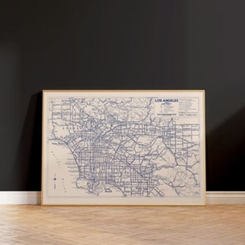 May include: A vintage map of Los Angeles, California, in a wooden frame. The map is printed in blue ink on a white background and shows the major roads, highways, and landmarks of the city. The map is titled "Los Angeles Area and Vicinity".