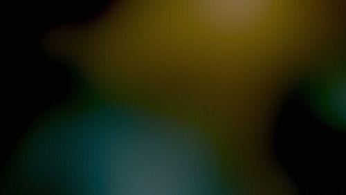 Dark abstract color blend background with blurred teal and olive green shapes and subtle vertical line texture