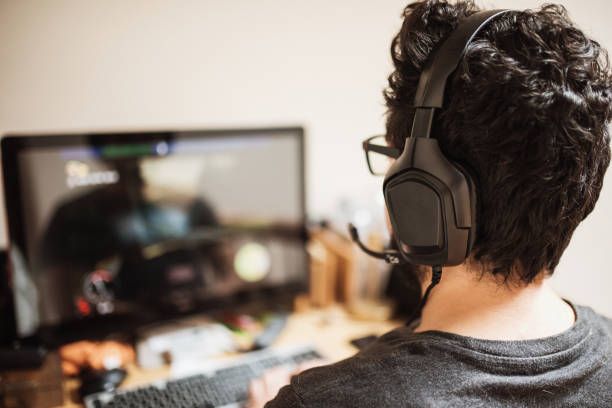hombre jugando videojuegos - audifonos gamer fotografías e imágenes de stock