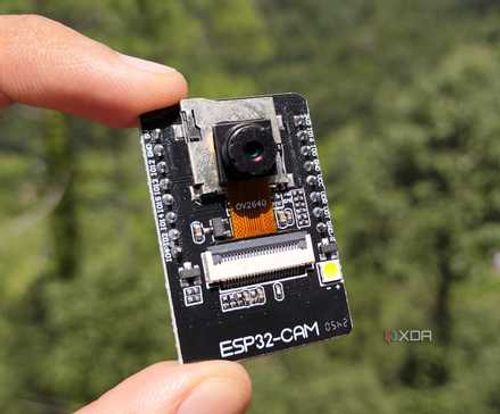 A person holding the ESP32 CAM board