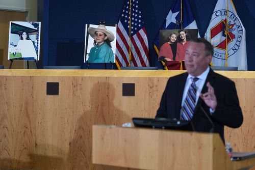 Detective Dan Jackson, speaking at a September 29 news conference about the Austin yogurt shop murders, was shot in the line of duty in an unrelated encounter during the investigation. The victims' photos are behind him.
