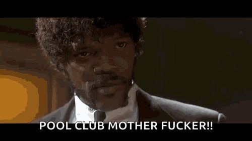 a man in a suit and tie is talking to another man in a room .