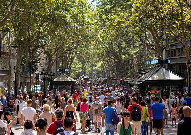 La Rambla in Barcelona during the day Barcelona, Spain - August 19, 2013: The busy high street of La Rambla in Barcelona during the day showing a large amount of people walking down the street la rambla barcelona stock pictures, royalty-free photos & images