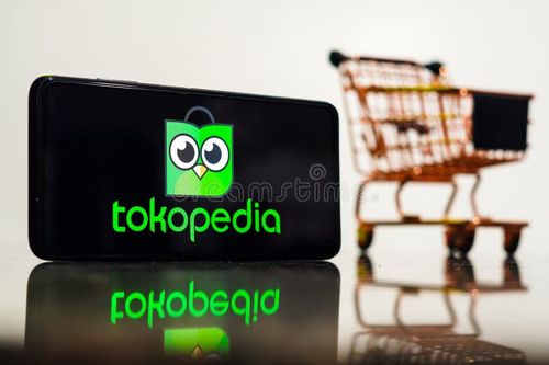 May 8, 2023, Brazil. In this photo illustration, the Tokopedia logo seen displayed on a smartphone along with a shopping cart.