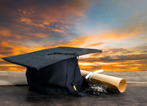 Graduation cap, hat with degree paper on wood table, sunset sky background Empty ready for your product display or montage. Bachelor degree stock images, royalty-free photos and pictures