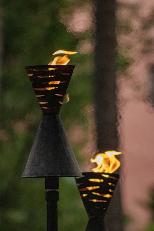 a couple of metal lamps sitting on top of a table