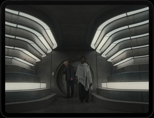 iPad Pro, display with image of 2 people entering a futuristic interior in the Apple TV+ series Silo.