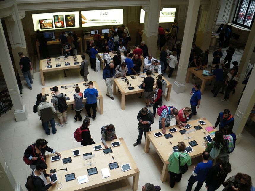 A crowded mobile phone store showcasing various smartphone brands on display.