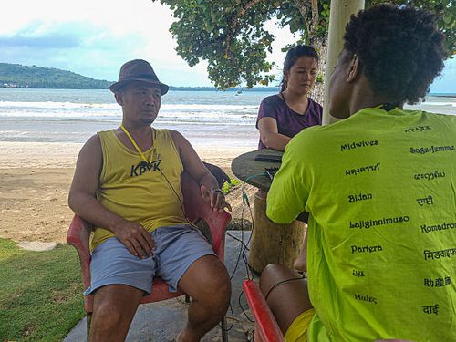 September 18th: The Funder Matius Wau of the Love one Niha Pelita Kasih Foundation is listening to the Midwife Alama Sylla outside of the Lagundri...