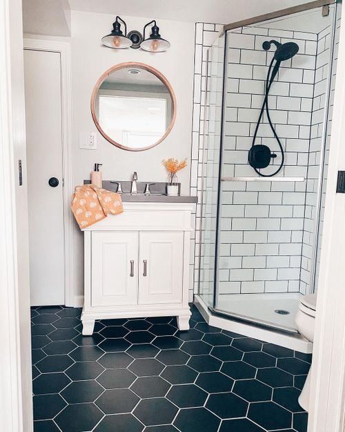 A small bathroom with vanity and mirror