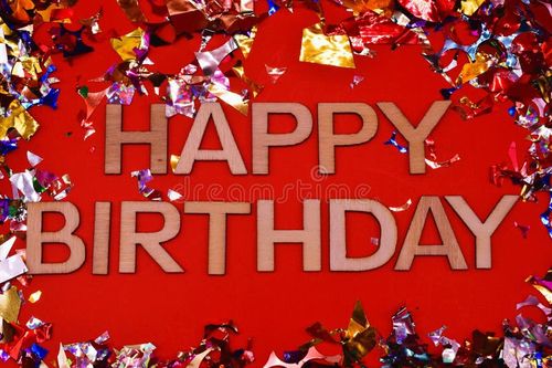 Happy birthday write between colorful shiny confetti on red background - happy birthday gift card background. Happy birthday stock images, royalty-free photos and pictures