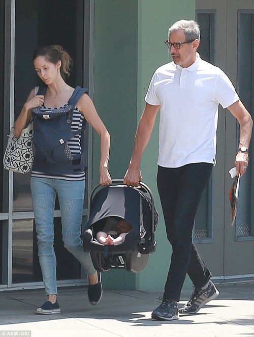Sharing the burden: Jeff Goldblum and wife Emilie team up to carry six-week-old Charlie Ocean for an outing in Los Angeles on Thursday