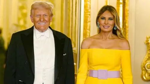 Donald and Melania Trump pose for a picture before the banquet at Windsor Castle, he wears a suit and tux and she wears a yellow dress.