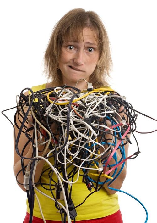 Crazy woman with tangle of cables and wires in hands isolated on white. Crazy woman stock images, royalty-free photos and pictures