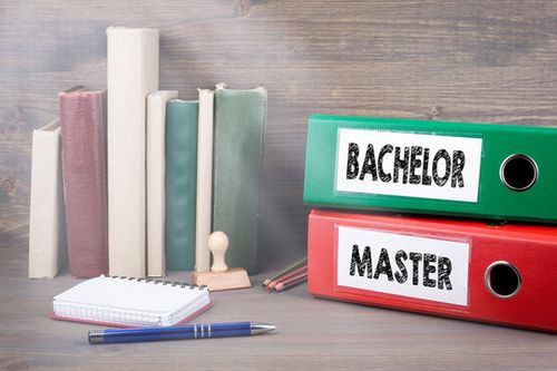 Bachelor and Master. Binders on desk in the office. Business background.