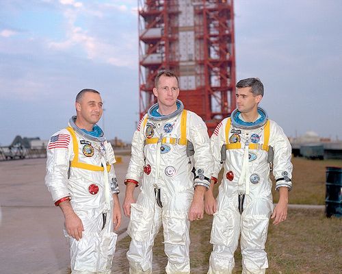 Grissom, White, and Chaffee in front of the launch pad containing their AS-204 space vehicle